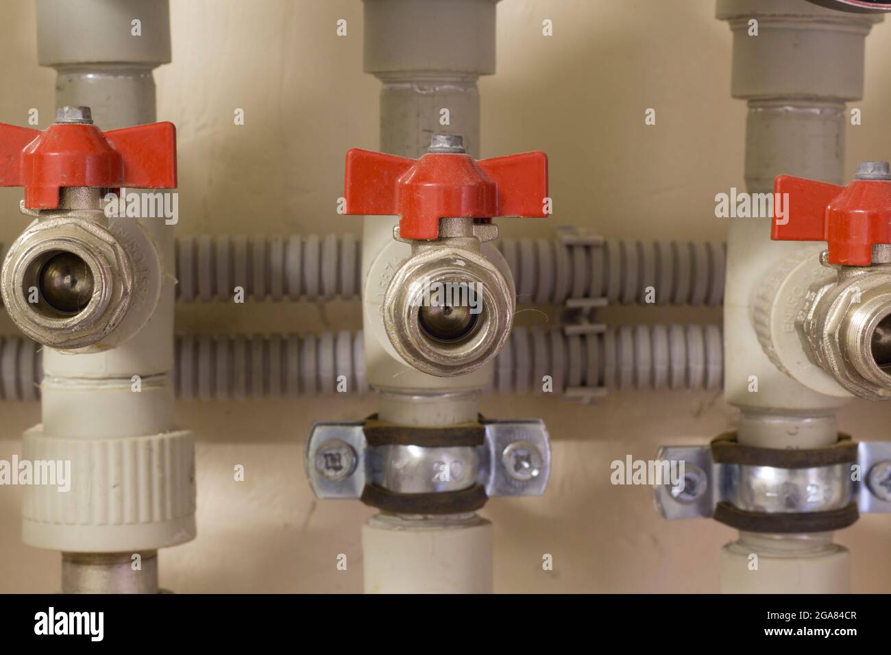 Distribution of plastic pipes with red valve and clamps Stock Photo Alamy