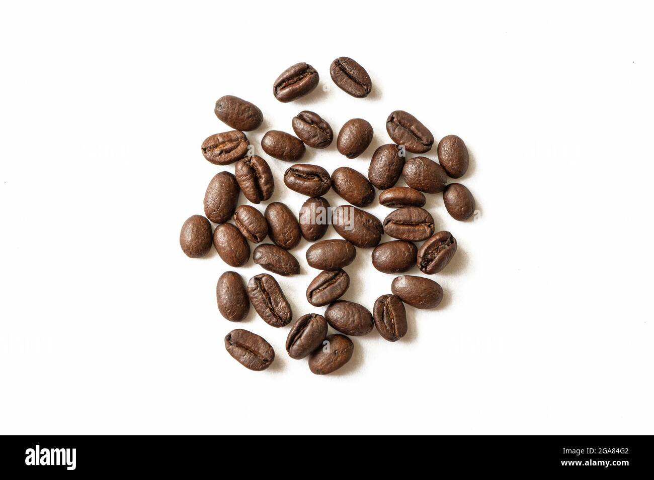 Roasted coffee beans pile isolated on white background. From top view ...