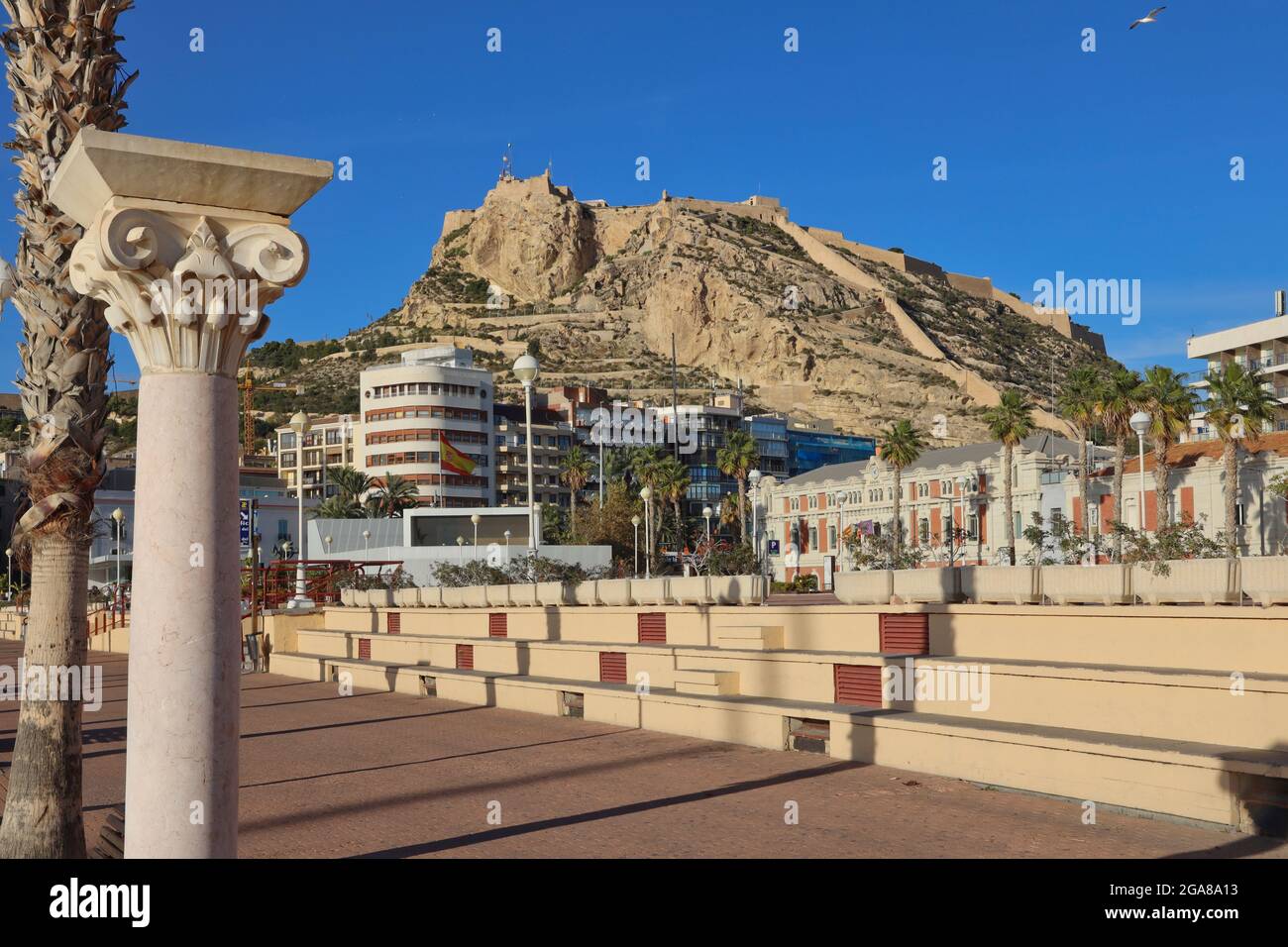The castle of Santa Barbara high up on a promontory overlooking the city of Alicante, Spain with the esplanade in the foreground Stock Photo