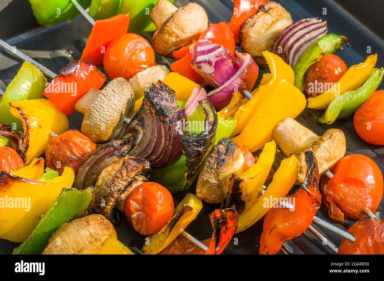 vegetable on skewer being grilled, summer BBQ in garden Stock Photo