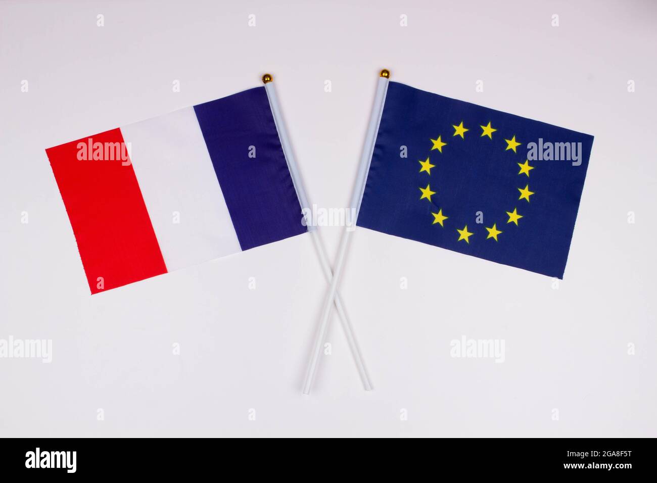 Flag of France and flag of European Union crossed with each other on a white background. Isolated. The image illustrates the relationship between coun Stock Photo