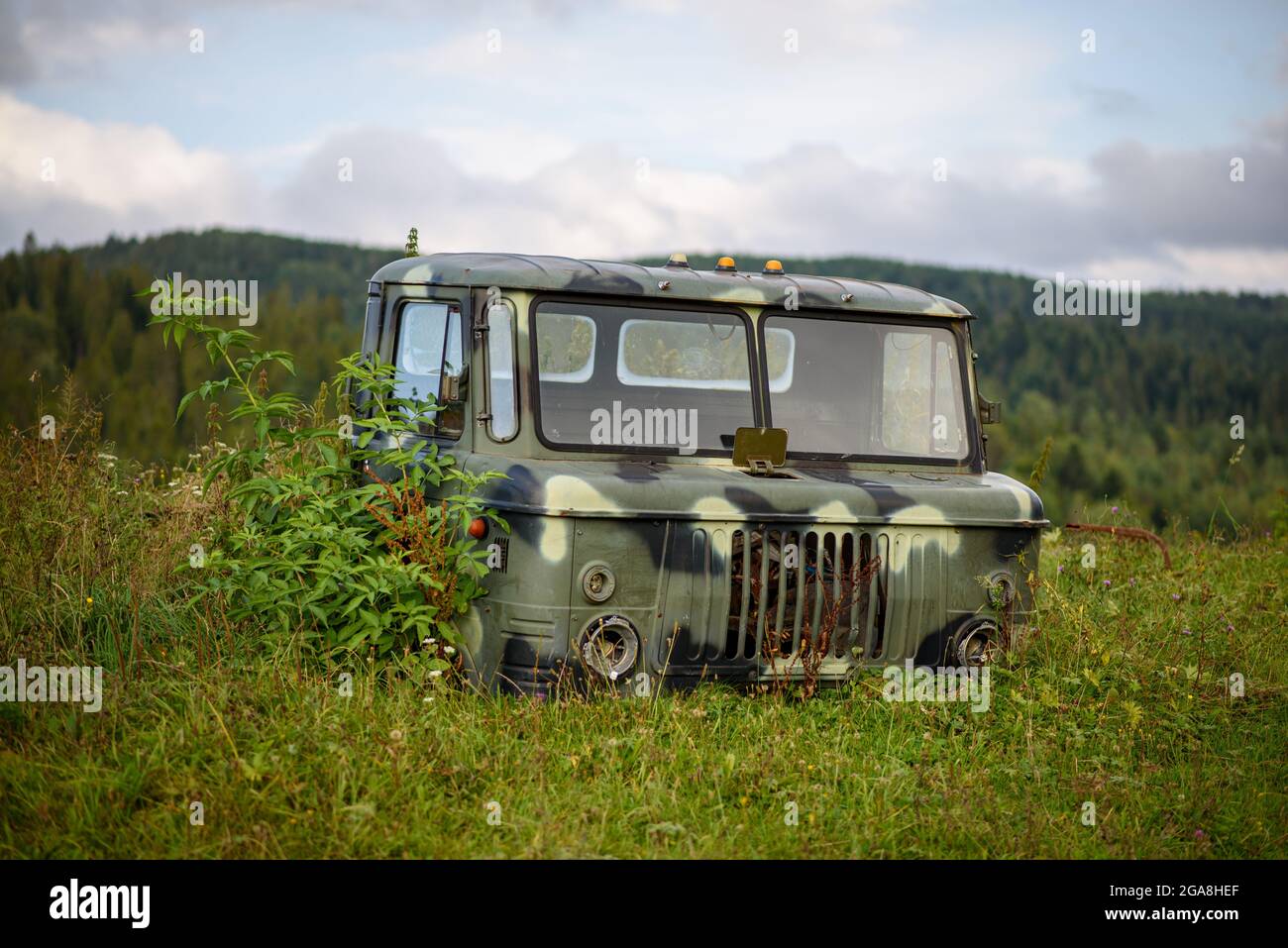 Abandoned vehicle among nature. Summer sunny day in mountains. Stock Photo