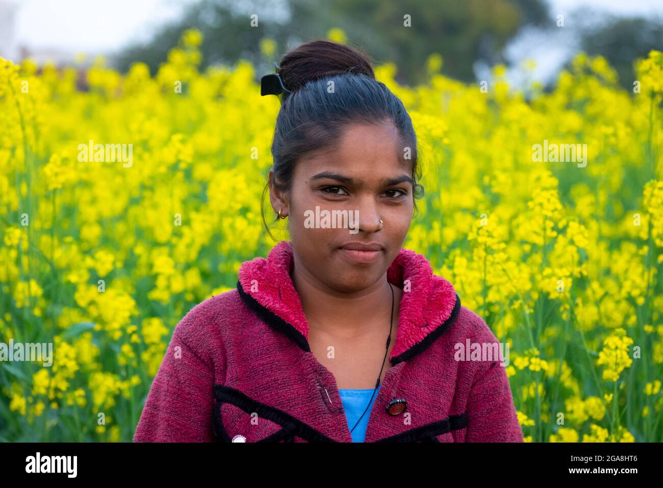 TIKAMGARH, MADHYA PRADESH, INDIA - JULY 23, 2021: Indian village girl at black mustard field. Stock Photo