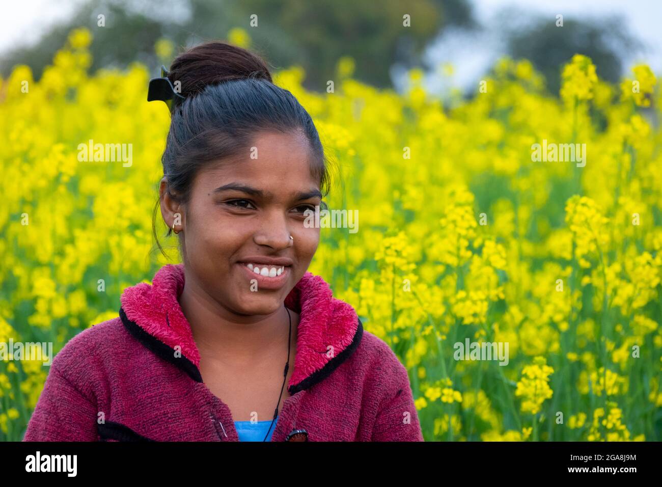 TIKAMGARH, MADHYA PRADESH, INDIA - JULY 23, 2021: Indian village girl at black mustard field. Stock Photo