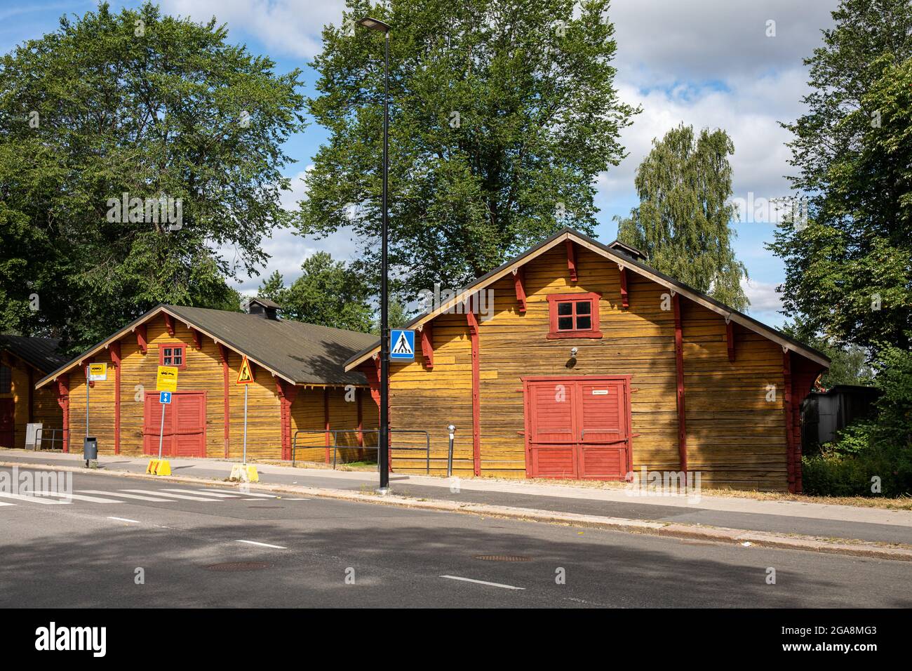 Old yellow wooden roadside warehouses or storages in Turku, Finland Stock Photo