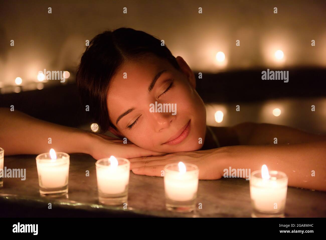 Beautiful Woman In Jacuzzi With Lit Candles At Spa Stock Photo Alamy