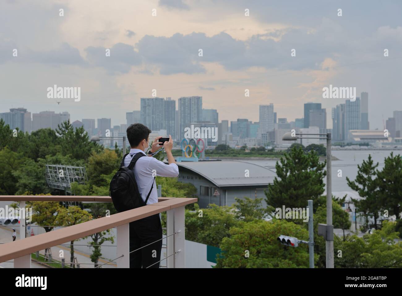 A man takes pictures of Odaiba Marine Park, a Tokyo 2020 Olympics sporting Venue for Triathlon and Marathon Swimming on day 7 of the Tokyo 2020 Olympic games. Stock Photo