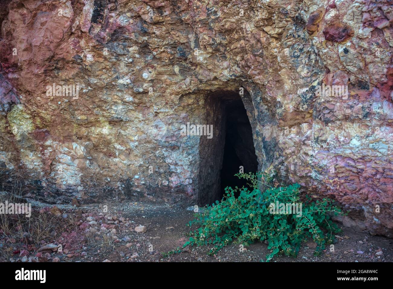 Abandoned gold mine adit in Troodos mountains near Analiontas, Cyprus. The colorful rocks are usual for this area rich of copper ore and sulfides Stock Photo