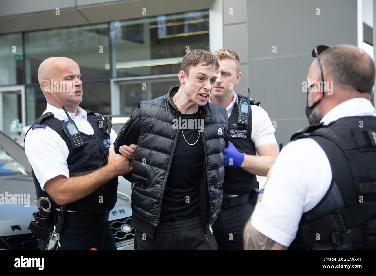 London, UK. 29th July, 2021. Officers from Operation Venice, which tackles  moped-enabled crime, arrest a suspect in Battersea, London after a chase.  Credit: Andy Sillett/Alamy Live News Stock Photo - Alamy