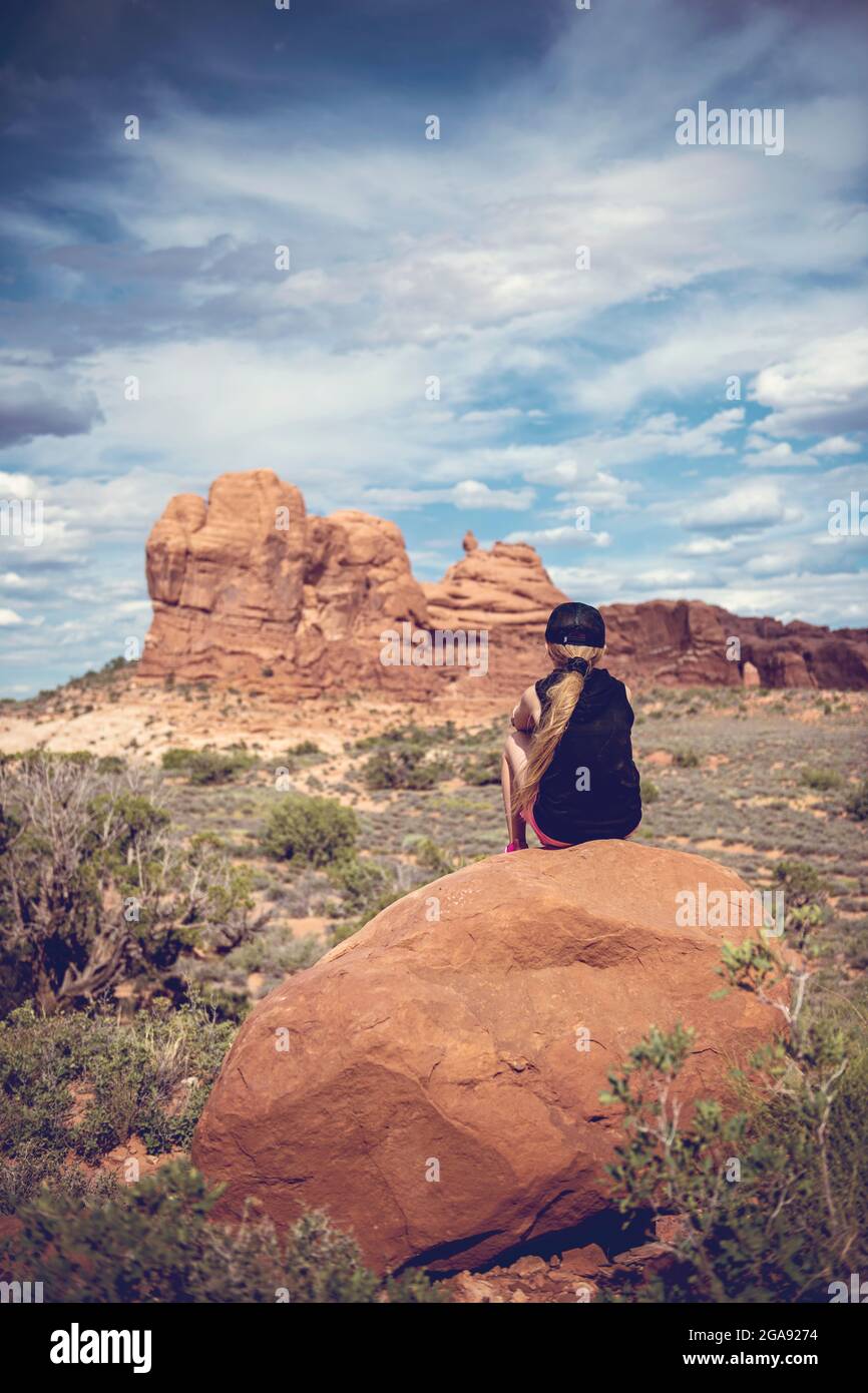 Girl on Rock in Arches National Park Stock Photo