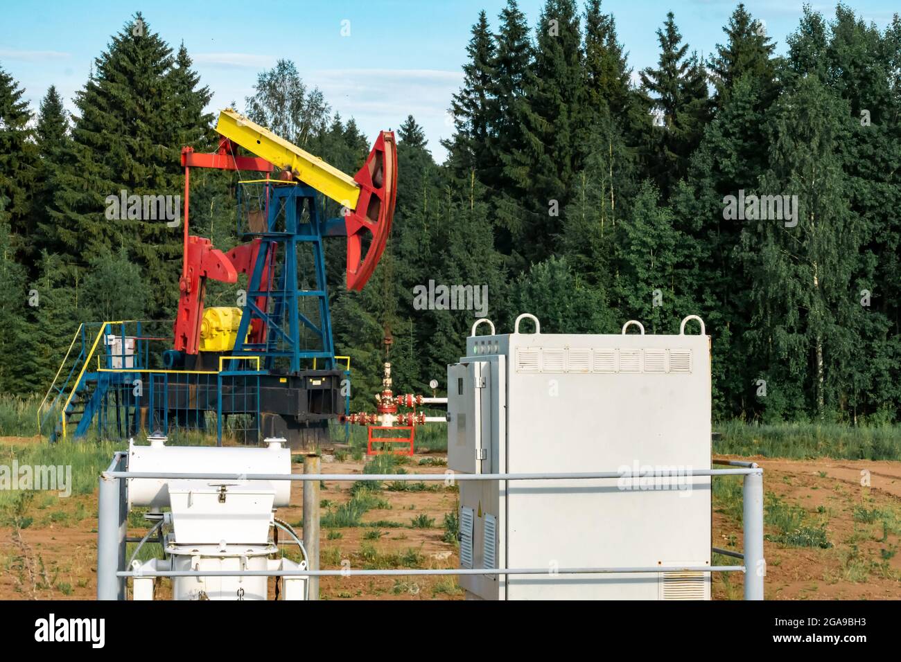 oil pumping station with pumpjack in a clearing in the forest Stock