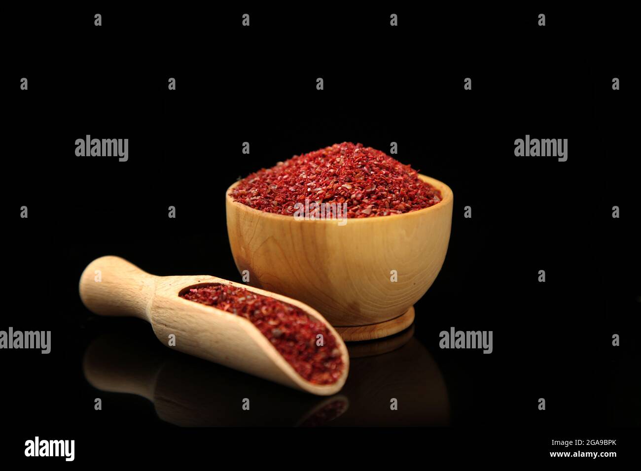 Sumac in wooden bowl, isolated on black Stock Photo Alamy