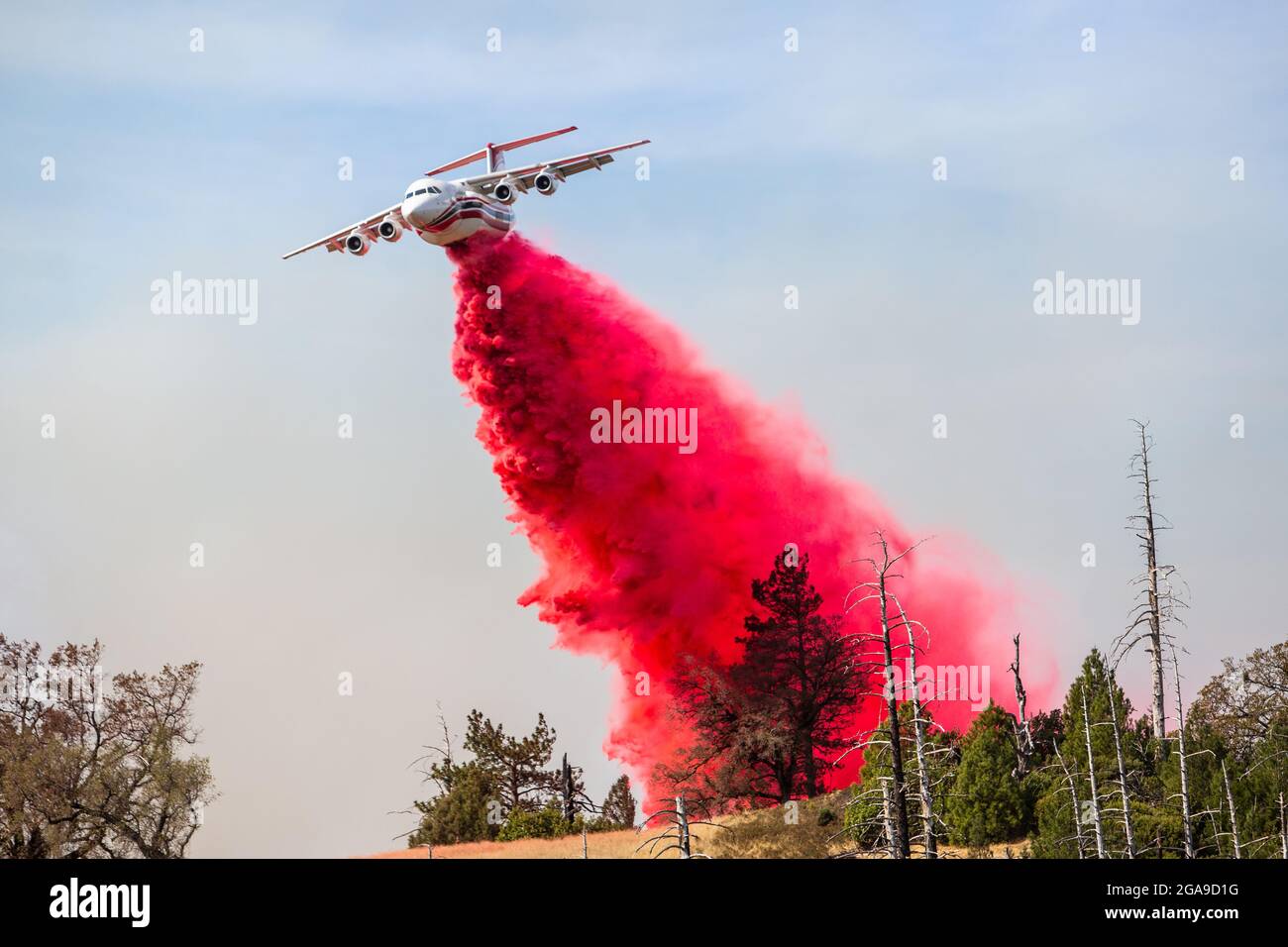 A air tanker drops retardant to create a fire break as the Kincade fire burns in Sonoma County, California on October 24th 2019. Stock Photo