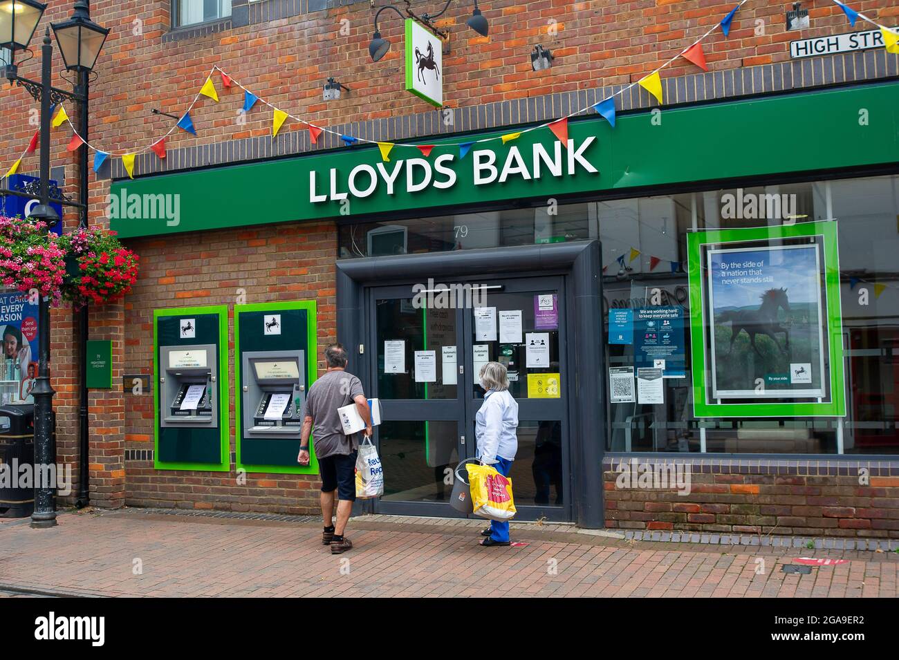 Chesham, Buckinghamshire, UK. 28th July, 2021. Customers frustrated that the Lloyds Bank had closed early today. Many businesses are having issues with staffing as their employees are having to self isolate due to the Covid-19 NHS Test and Trace app having pinged them. Credit: Maureen McLean/Alamy Stock Photo