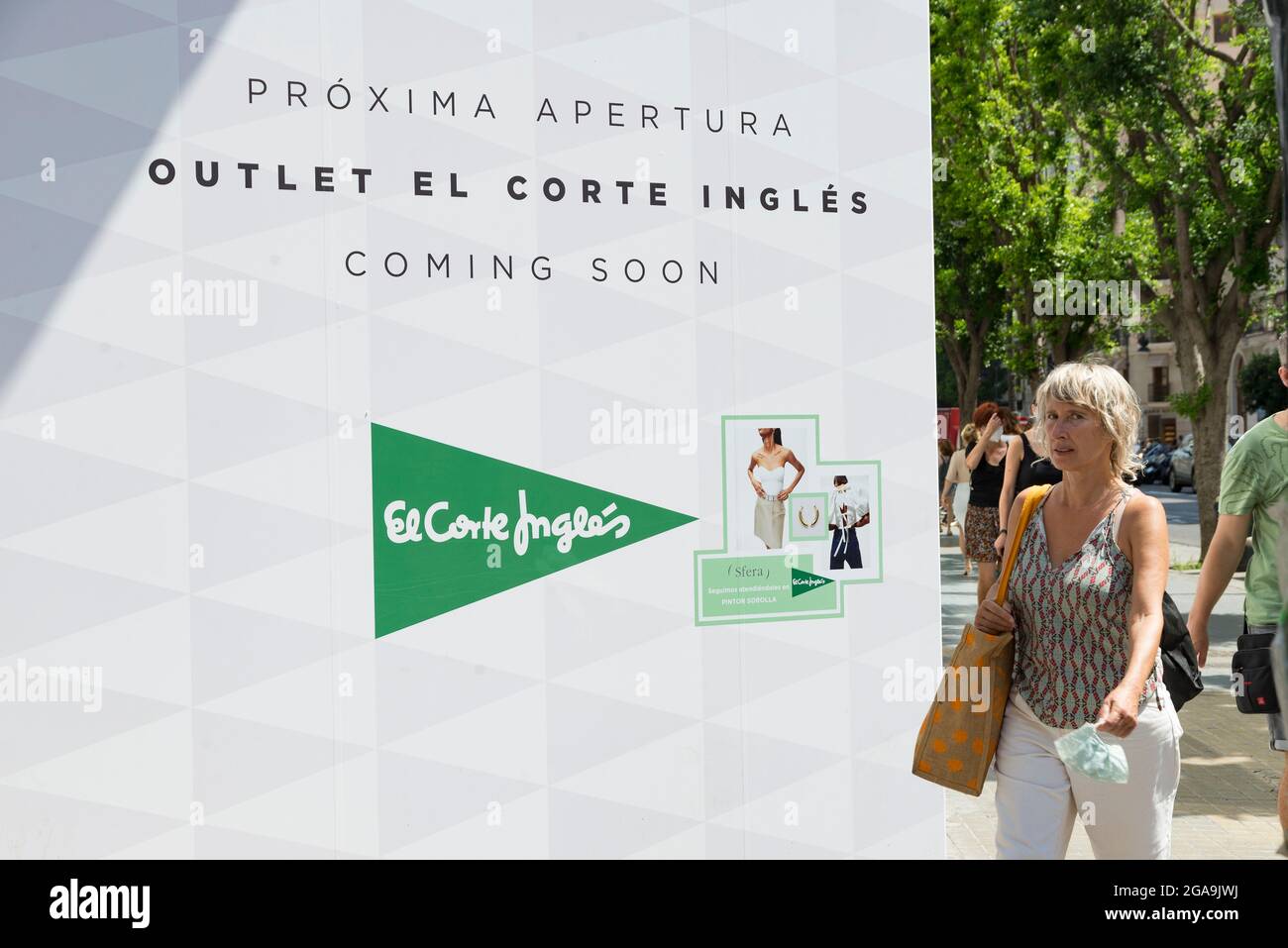 A woman walking by the El Corte Ingles department store under construction  for the upcoming outlet opening Stock Photo - Alamy