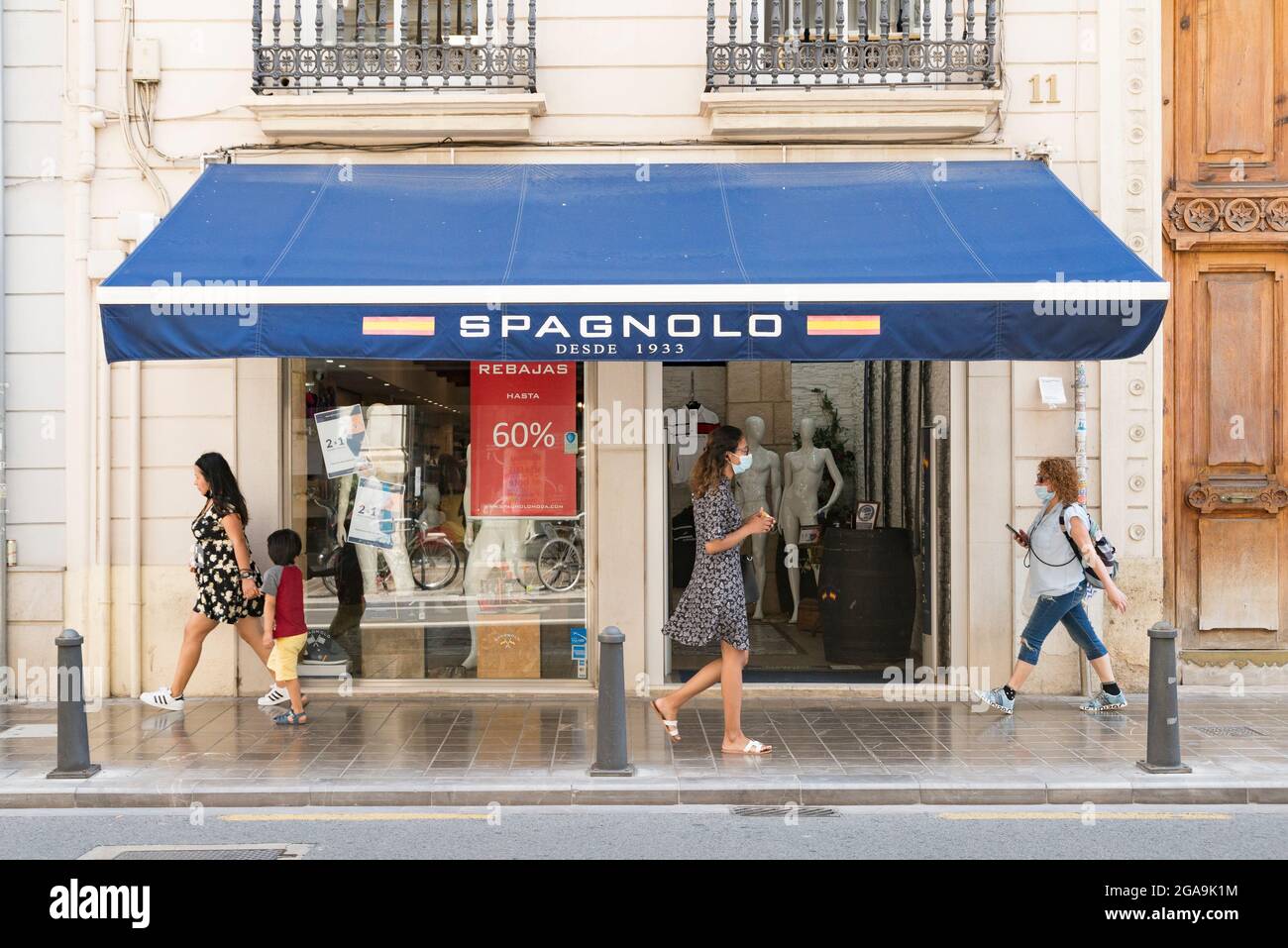 People walk by the Spagnolo clothing store in Valencia Stock Photo Alamy