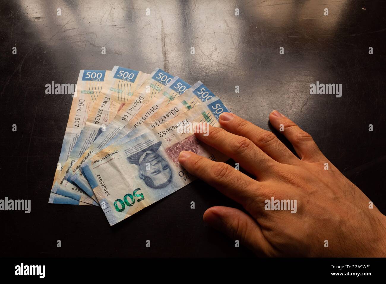 hand holding mexican money called pesos Stock Photo Alamy