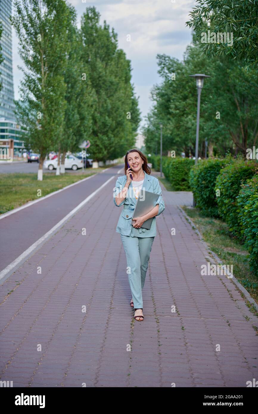 Business woman walking laptop hi-res stock photography and images - Alamy