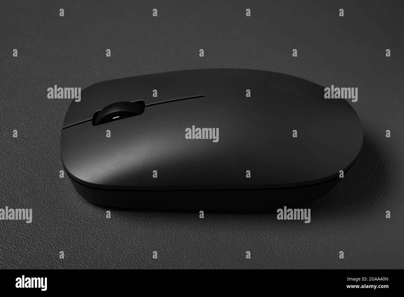 side view black wireless mouse on a dark background Stock Photo