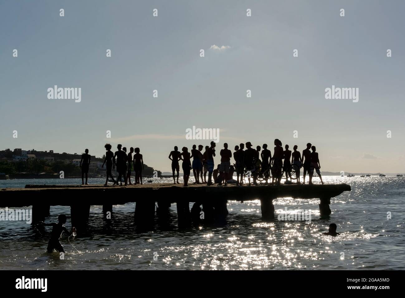Young people on the famous Crush Bridge on a sunny summer day. Praia da Ribeira in Salvador, Bahia, Brazil. Stock Photo