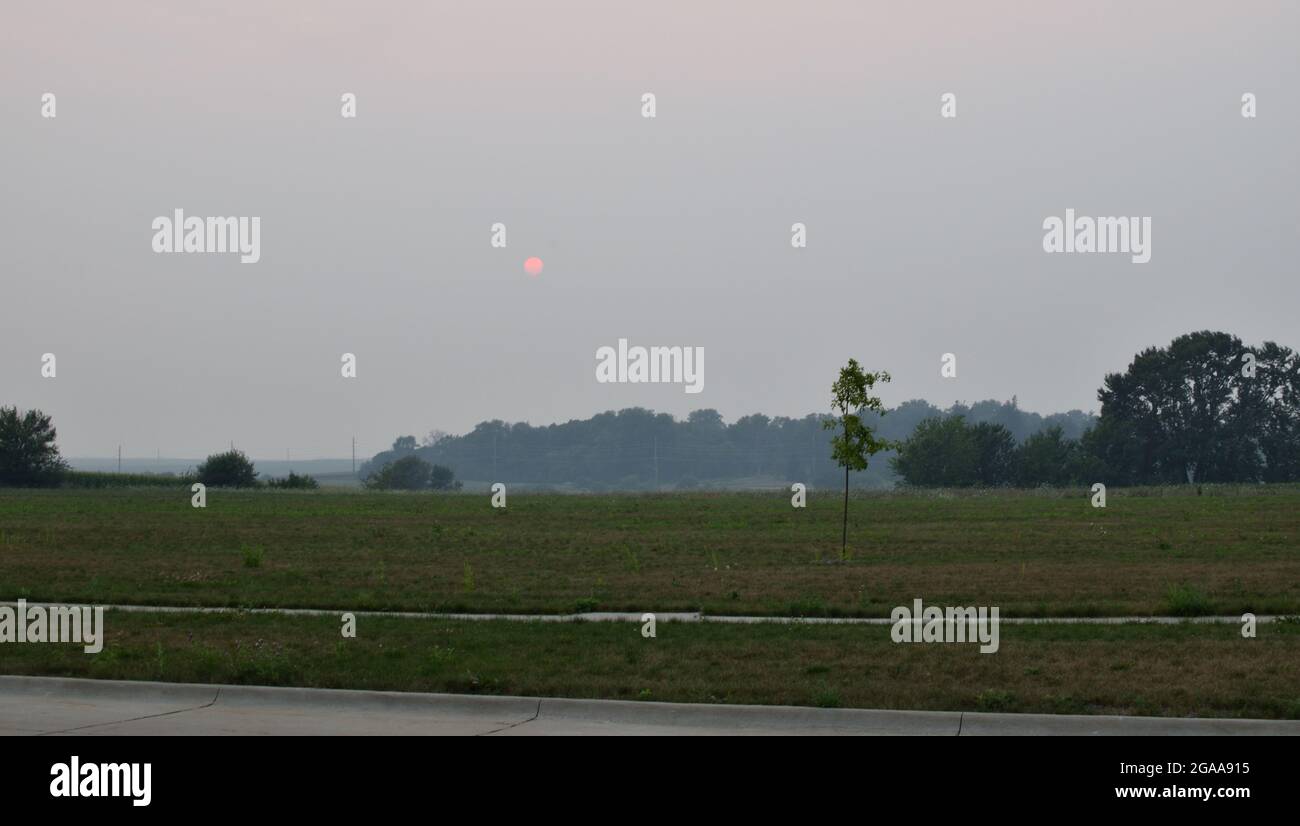 Smoky haze over Cedar Falls, IA due to wildfires in Southern Canada and Western United States.  Photos taken in the evening of July 29, 2021 Stock Photo