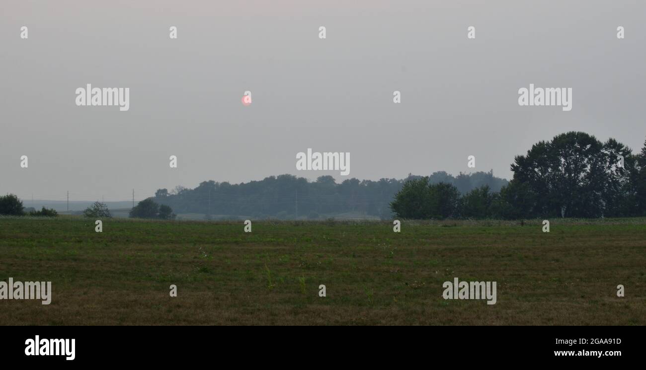 Smoky haze over Cedar Falls, IA due to wildfires in Southern Canada and Western United States.  Photos taken in the evening of July 29, 2021 Stock Photo