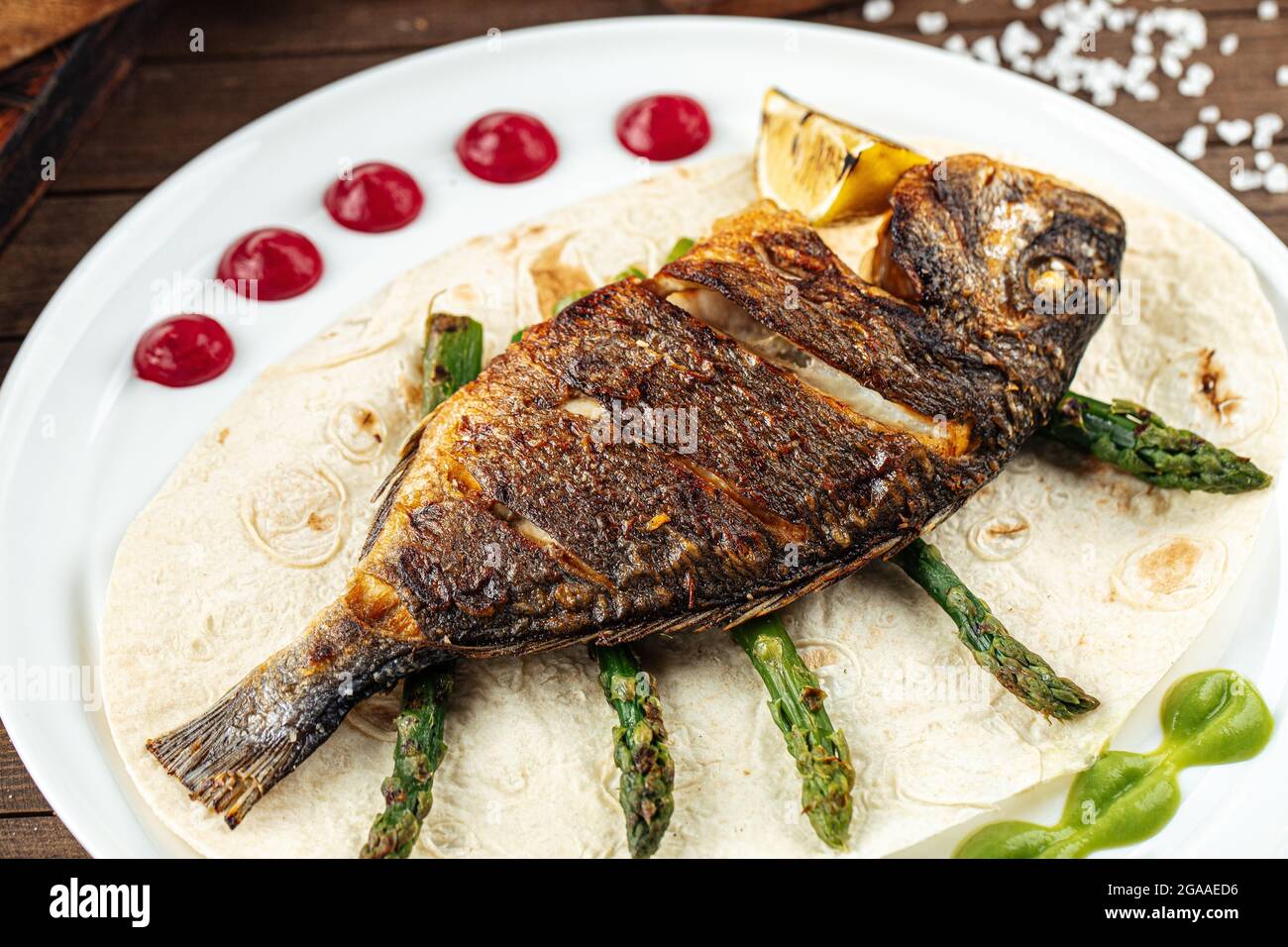 Dish of gourmet grilled dorada fish Stock Photo - Alamy