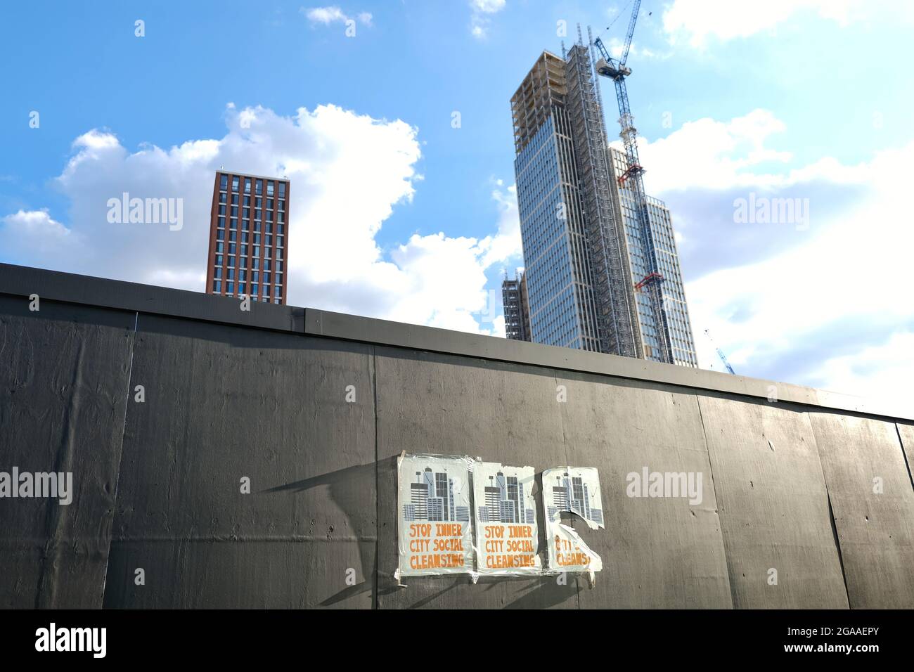 Posters appear on building site hoardings in Vauxhall protesting against social cleansing as property developers gentrify inner city areas. Stock Photo