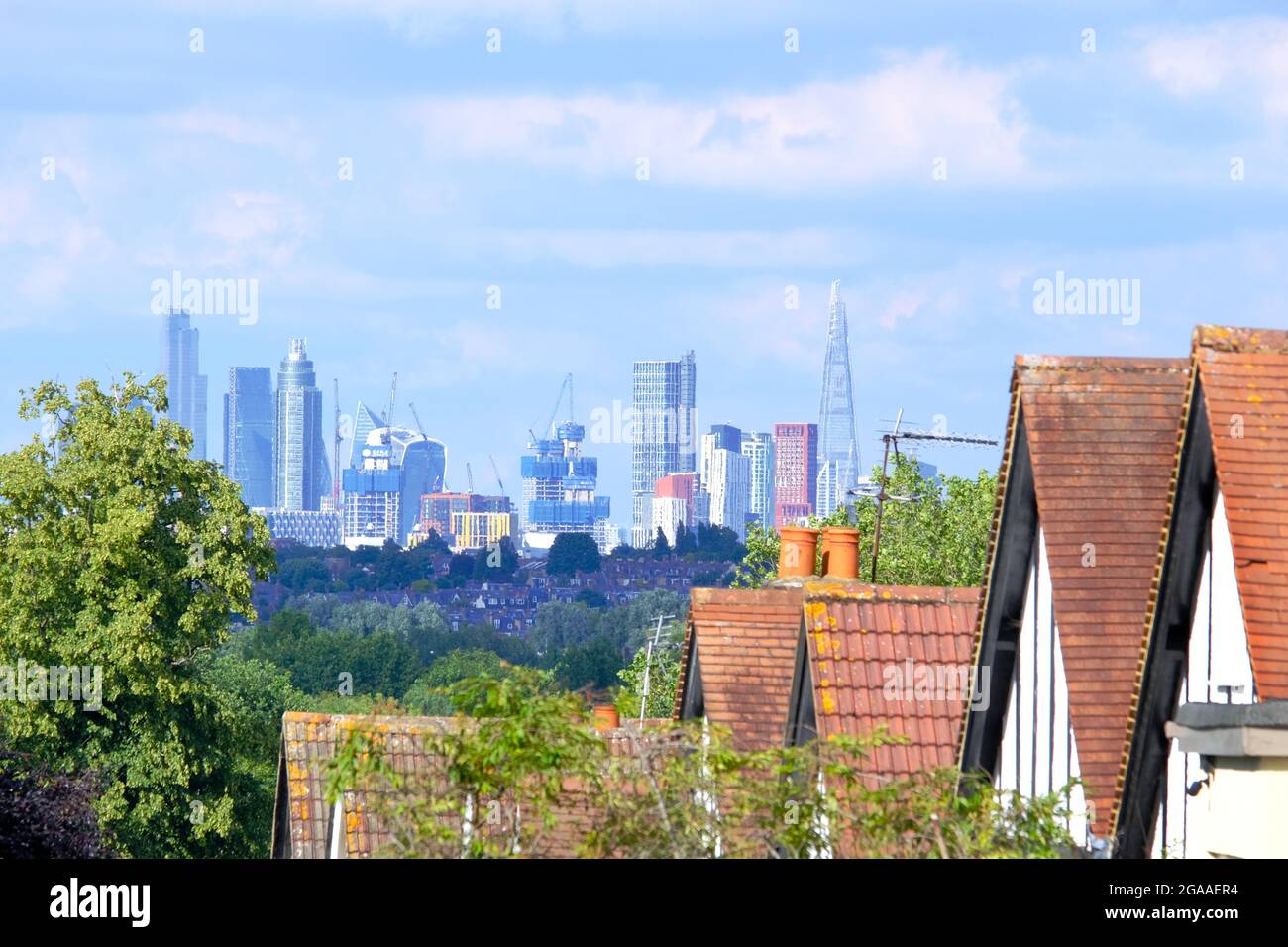 View over Wimbledon Village rooftops where the London skyline from Wandsworth, Vauxhall and the City of London can be seen in the distance. Stock Photo