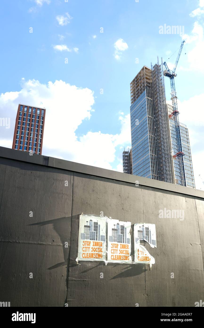 Posters appear on building site hoardings in Vauxhall protesting against social cleansing as property developers gentrify inner city areas. Stock Photo