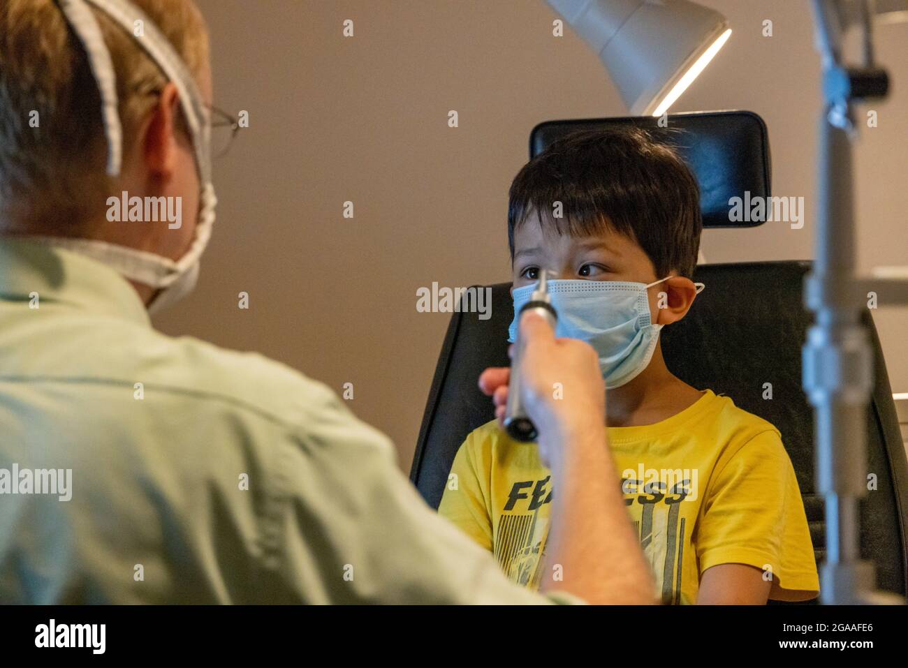 Boy getting eye exam at optometrist's office, USA Stock Photo