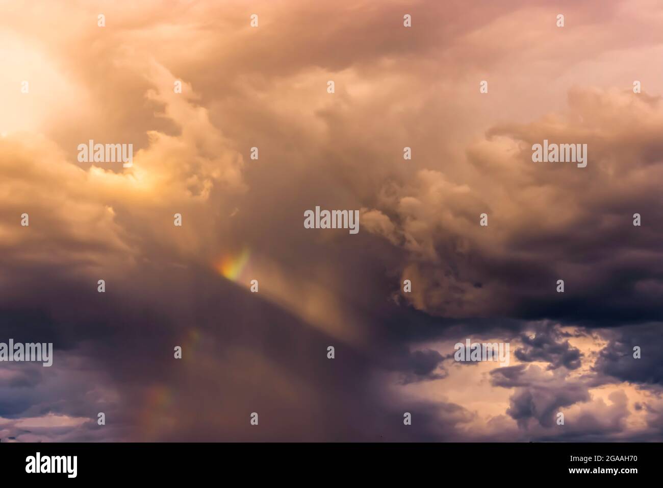 A miniature rainbow in the clouds in Santa Fe Stock Photo