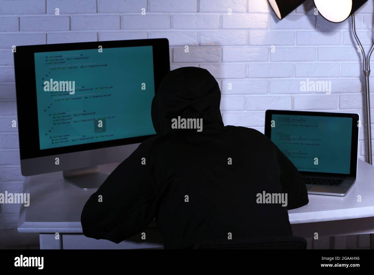 Hacker with computer and laptop Stock Photo - Alamy