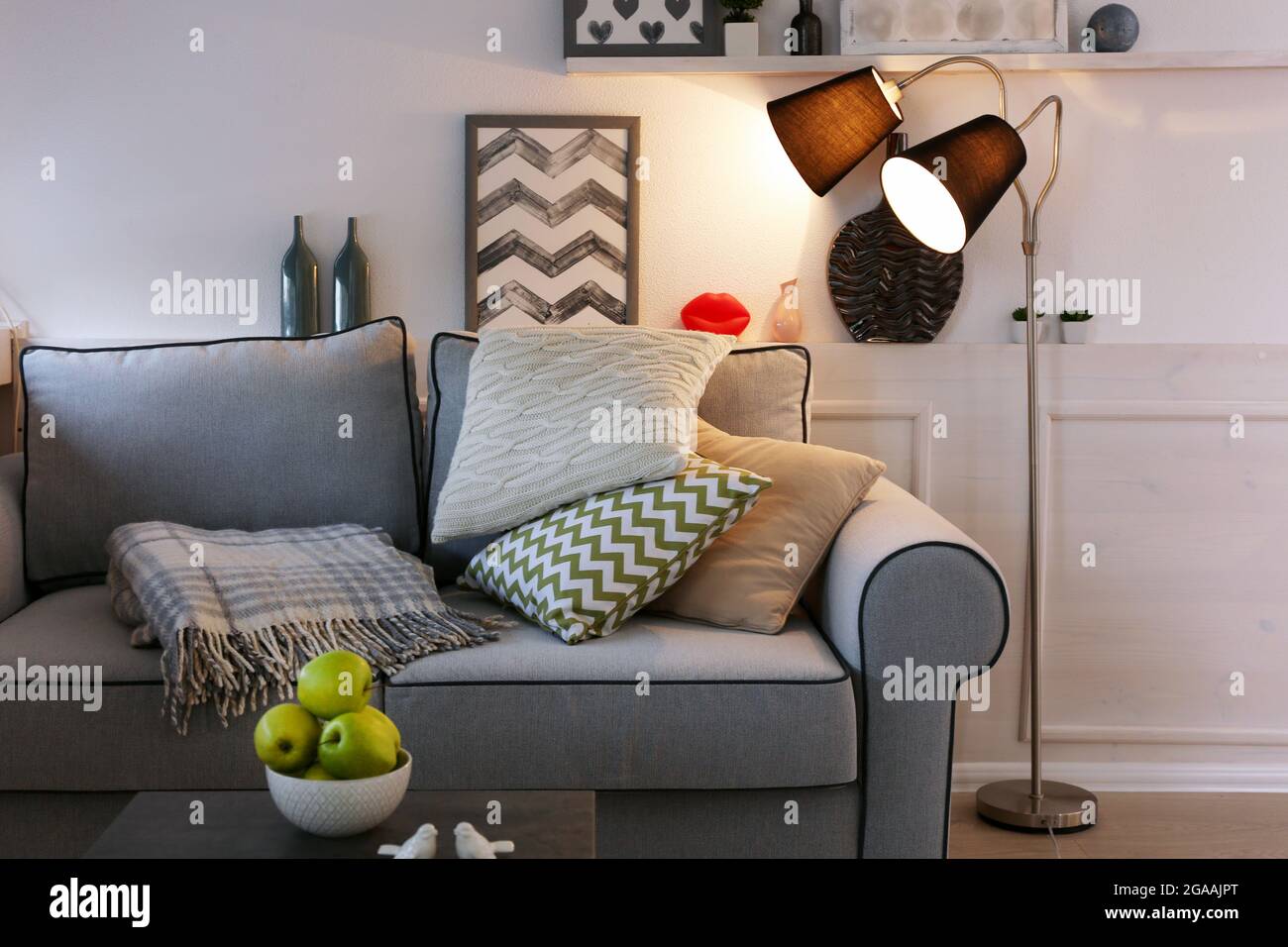 Beautiful modern living room with grey sofa and floor lamp Stock Photo ...