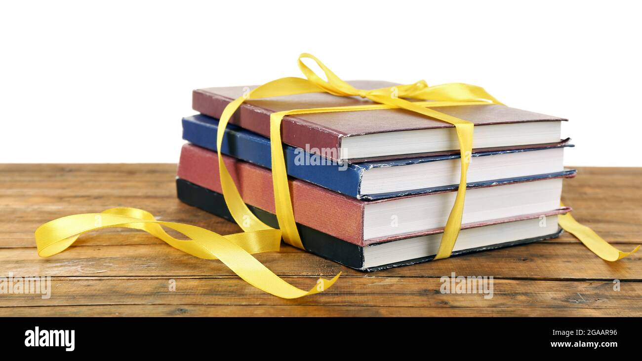 Book Stack With Ribbon Mark Stack of books with ribbon on table isolated on white Stock Photo - Alamy
