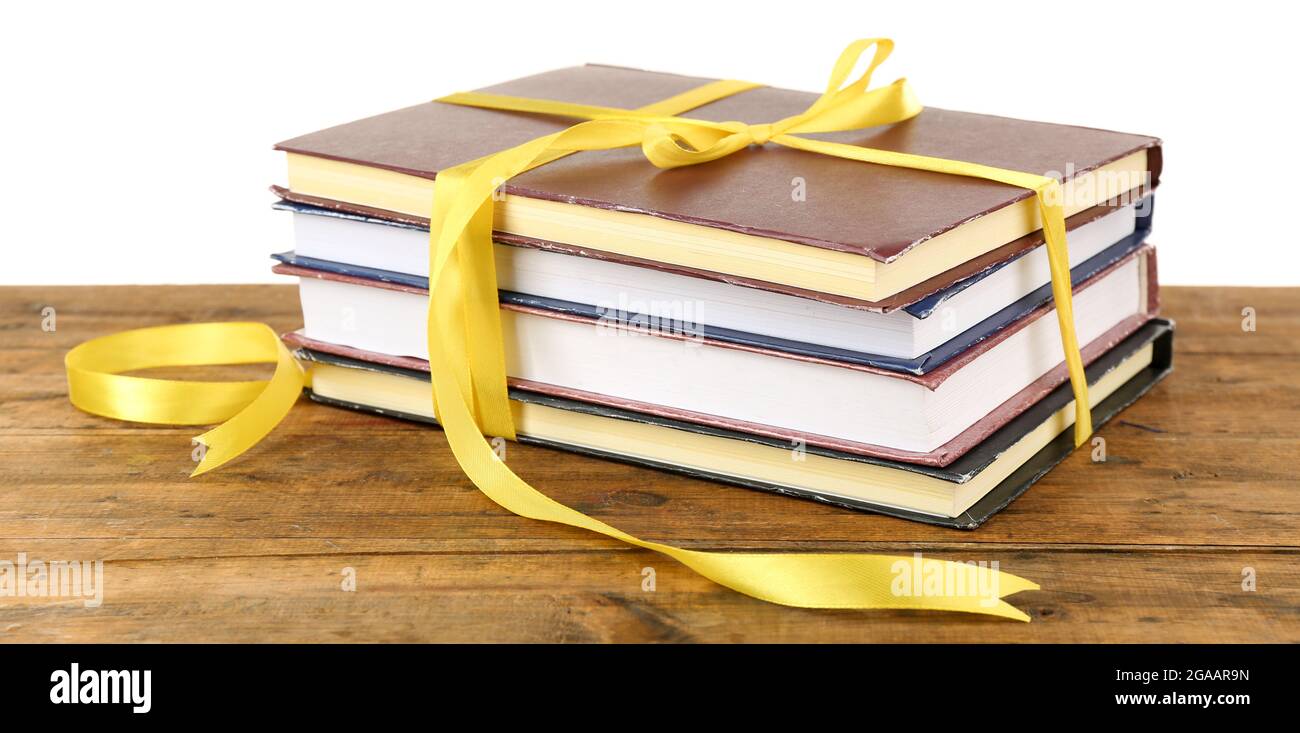 Book Stack With Ribbon Mark Stack of books with ribbon on table isolated on white Stock Photo - Alamy
