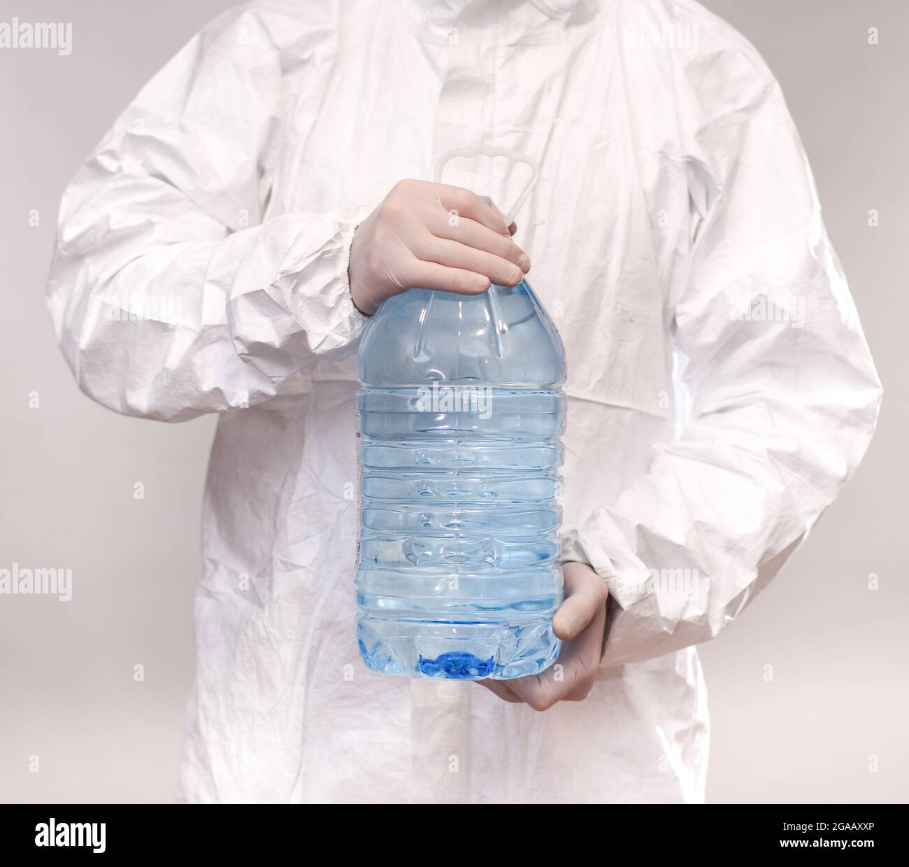 https://c8.alamy.com/comp/2GAAXXP/a-man-holds-a-large-full-plastic-transparent-bottle-with-water-liquid-2GAAXXP.jpg