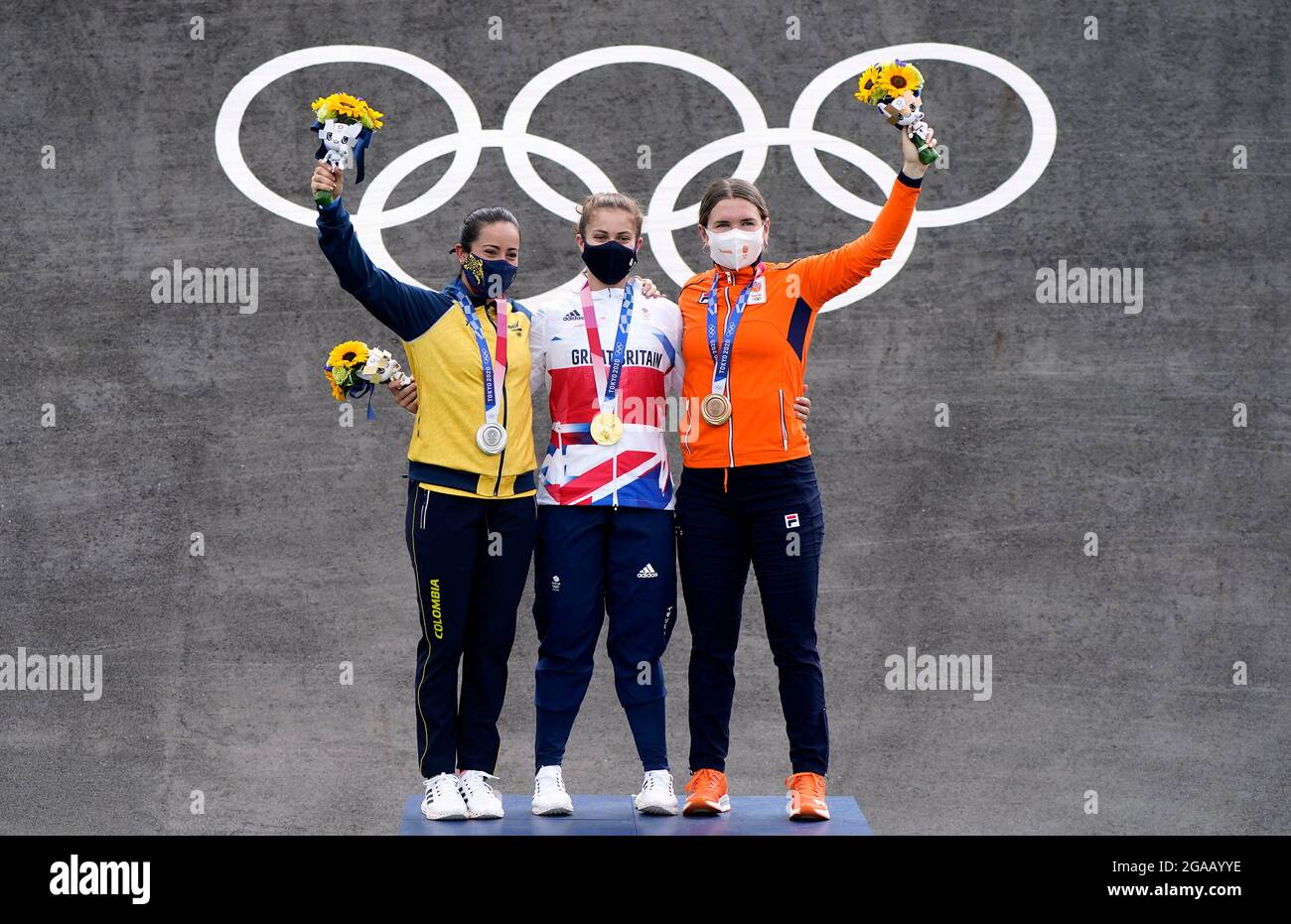 Great Britain's Bethany Shriever collects her Gold medal alongside Colombia’s Mariana Pajon (Silver) and Netherland’s Merel Smulders (Bronze) for the Cycling BMX Racing at the Ariake Urban Sports Park on the seventh day of the Tokyo 2020 Olympic Games in Japan. Picture date: Friday July 30, 2021. Stock Photo