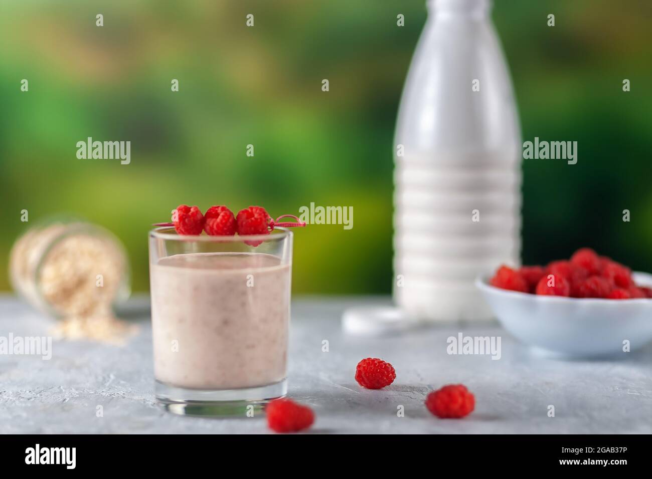 Healthy dietary food. Oatmeal milkshake with bananas and raspberries. Stock Photo