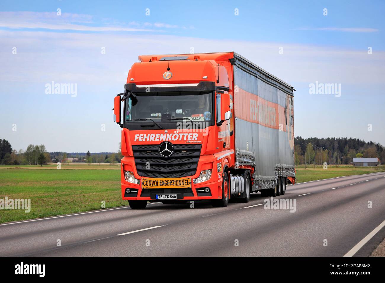 Orange Mercedes-Benz Actros truck of Fehrenkötter GmbH, Germany, pulling special trailer on road. Exceptional load. Marttila, Finland. May 14, 2021. Stock Photo