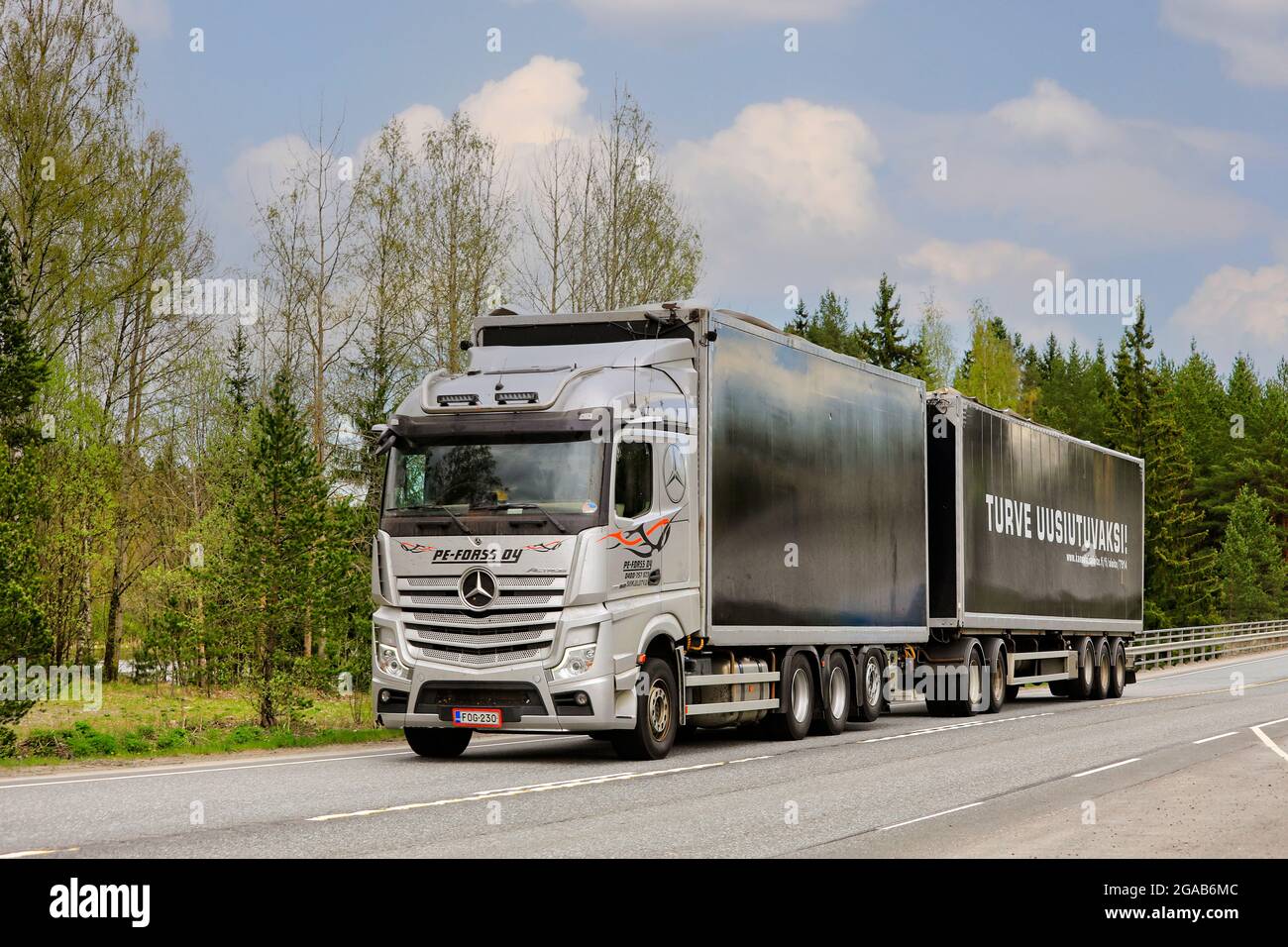 Silver Mercedes-Benz Actros truck of PE-Forss Oy pulls peat