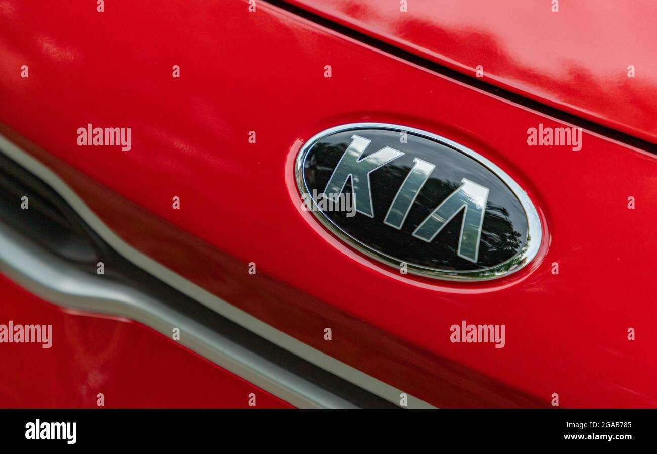 A picture of the Kia logo on a red car. Stock Photo