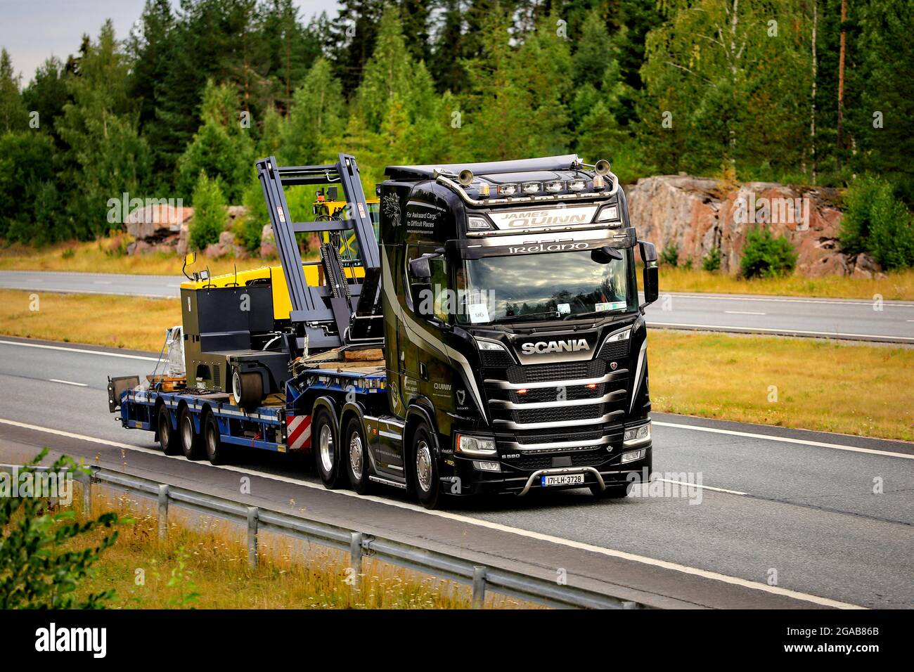 Black Scania S580 truck semi trailer of James Quinn Transport, Ireland, for heavy haulage on motorway E18 in Salo, Finland. July 23, 2021. Stock Photo
