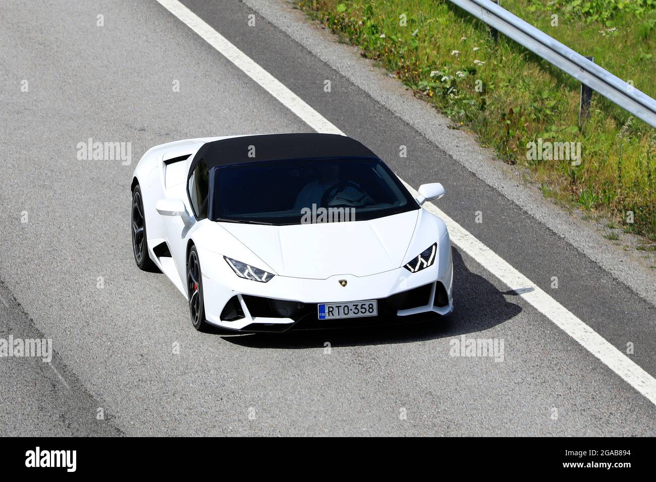 White Lamborghini Huracán LP 580-2 Spyder supercar at speed on motorway E18, elevated view. Salo, Finland. July 23, 2021. Stock Photo