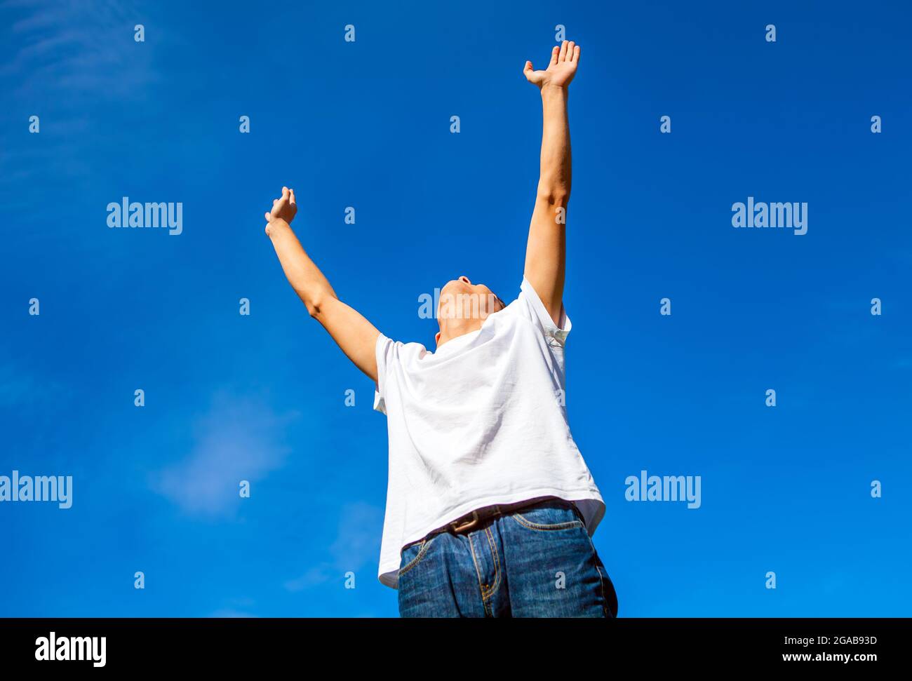 Happy Young Man with Hands Up on the Sky Background Stock Photo - Alamy