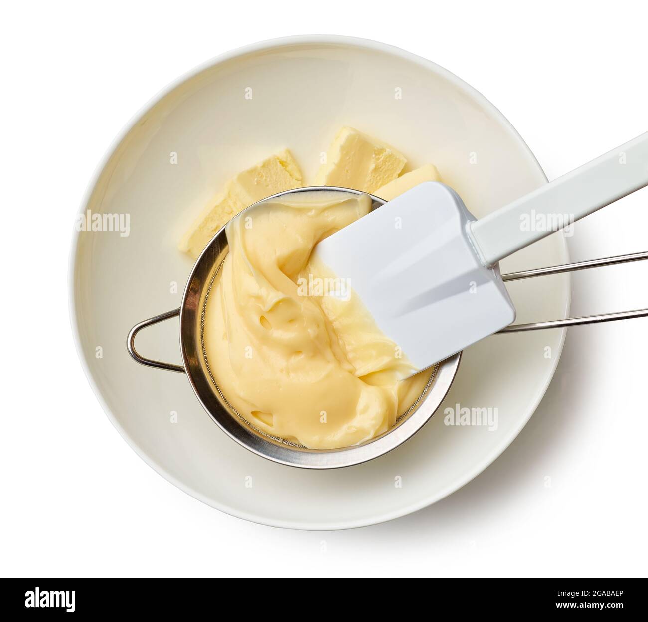 custard cream in a strainer. chef adds custard cream to butter in a bowl isolated on white background, top view Stock Photo