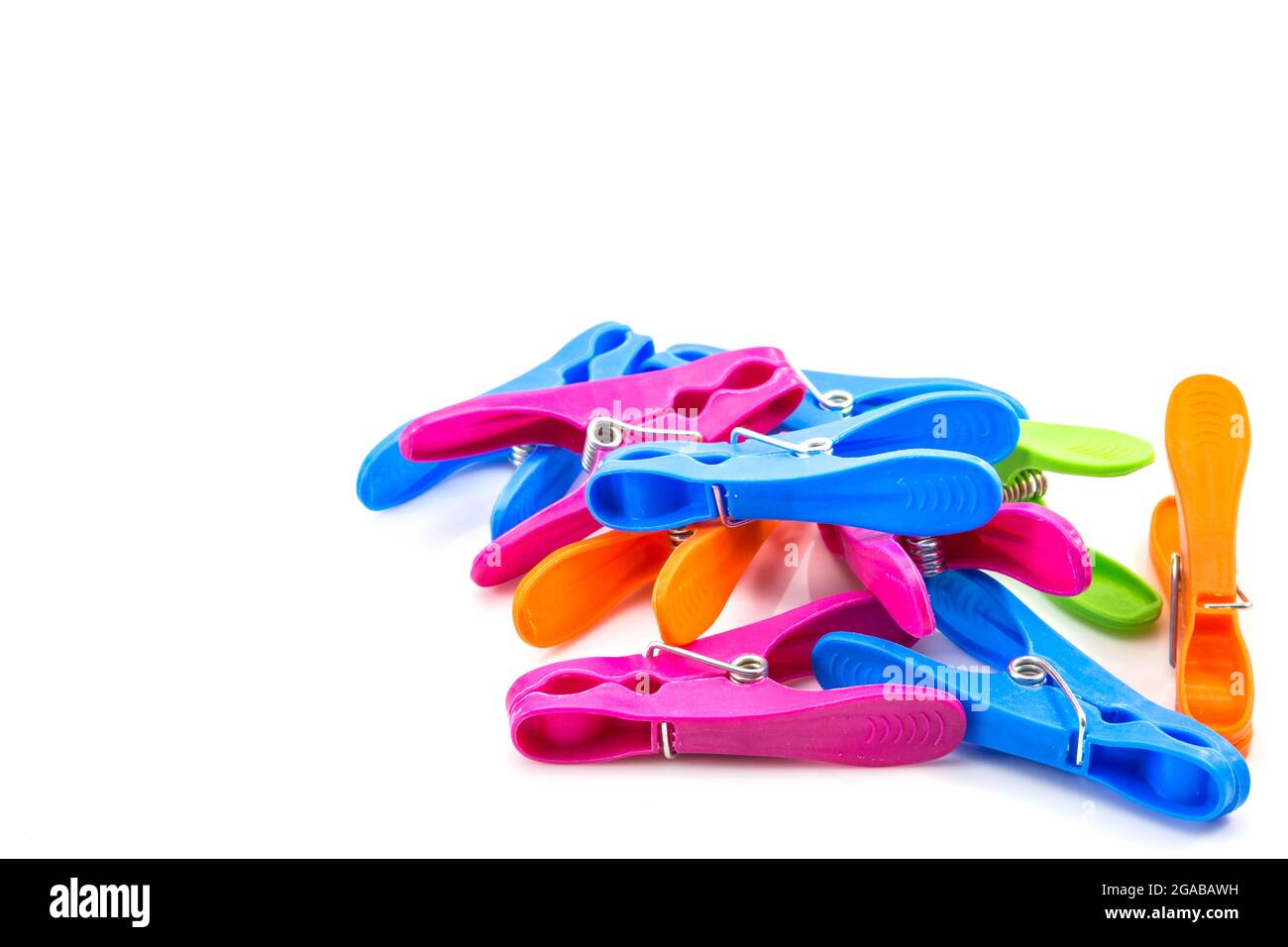 colorful plastic clothes pegs on white background Stock Photo