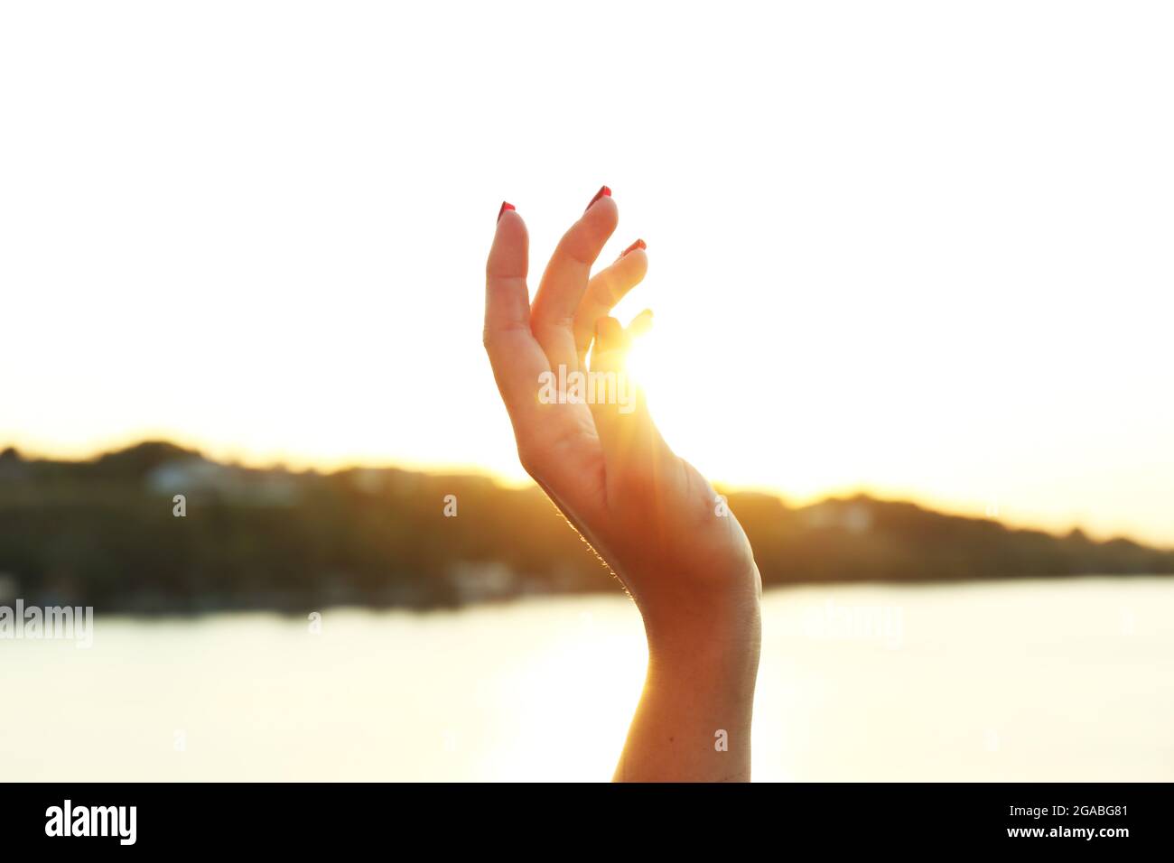 Female hand on sunny sky background Stock Photo - Alamy
