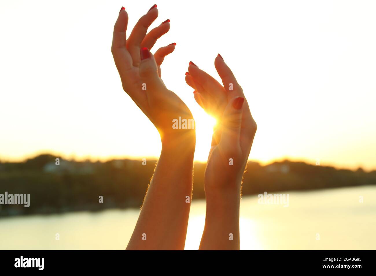 Female hands on sunny sky background Stock Photo - Alamy