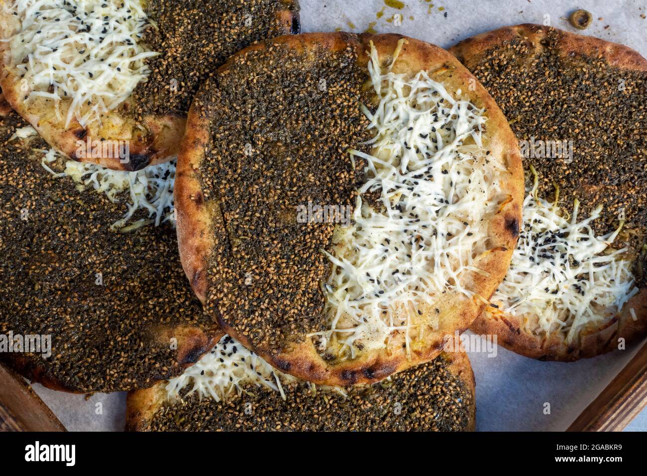 Stack of traditional Palestinian food called Manakish consisting of dough topped with thyme